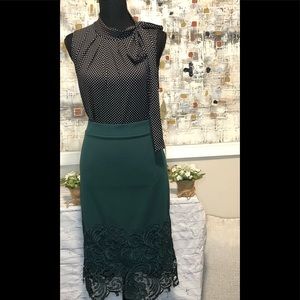 Tiffany and Grey black and white polka dot sleeveless blouse with side bow tie.